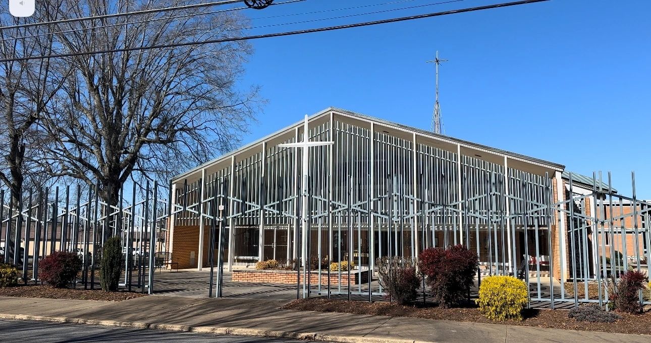 A building with metal bars around it and trees in the background.