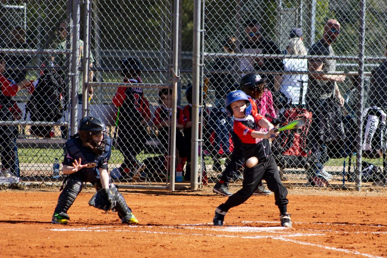 A baseball player swinging at the ball during a game.