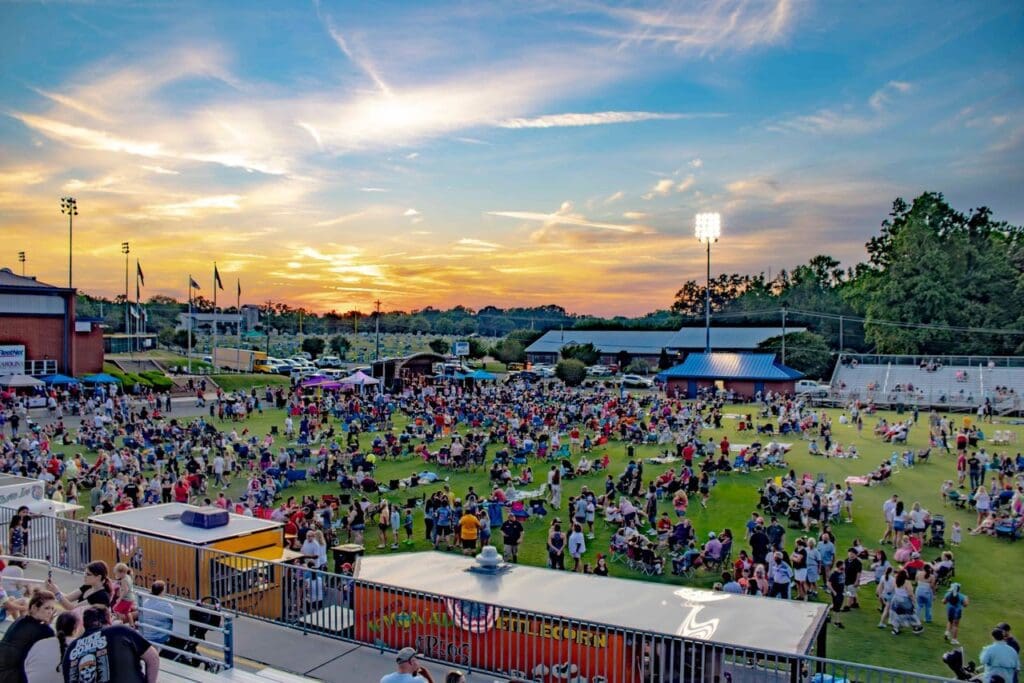 A crowd of people gathered in an open field.