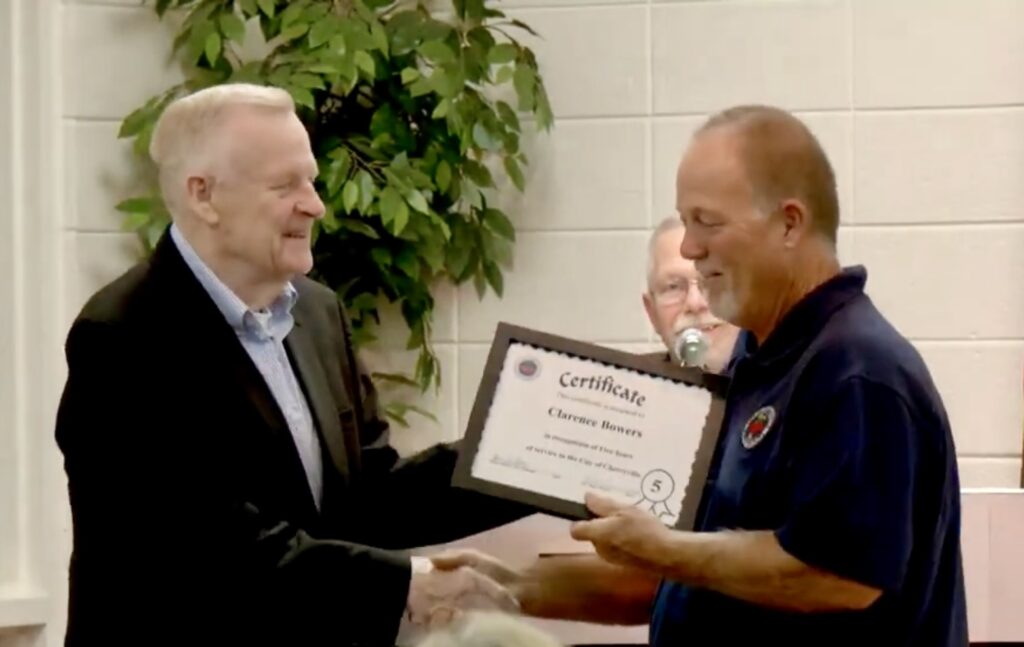 Clarence Bowers receiving a certificate of appreciation for years of service to the city from Cherryville Mayor H.L. Beam.