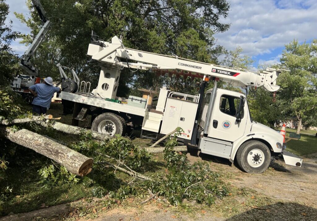 a City of CHerryville Work Truck clearing downed trees.