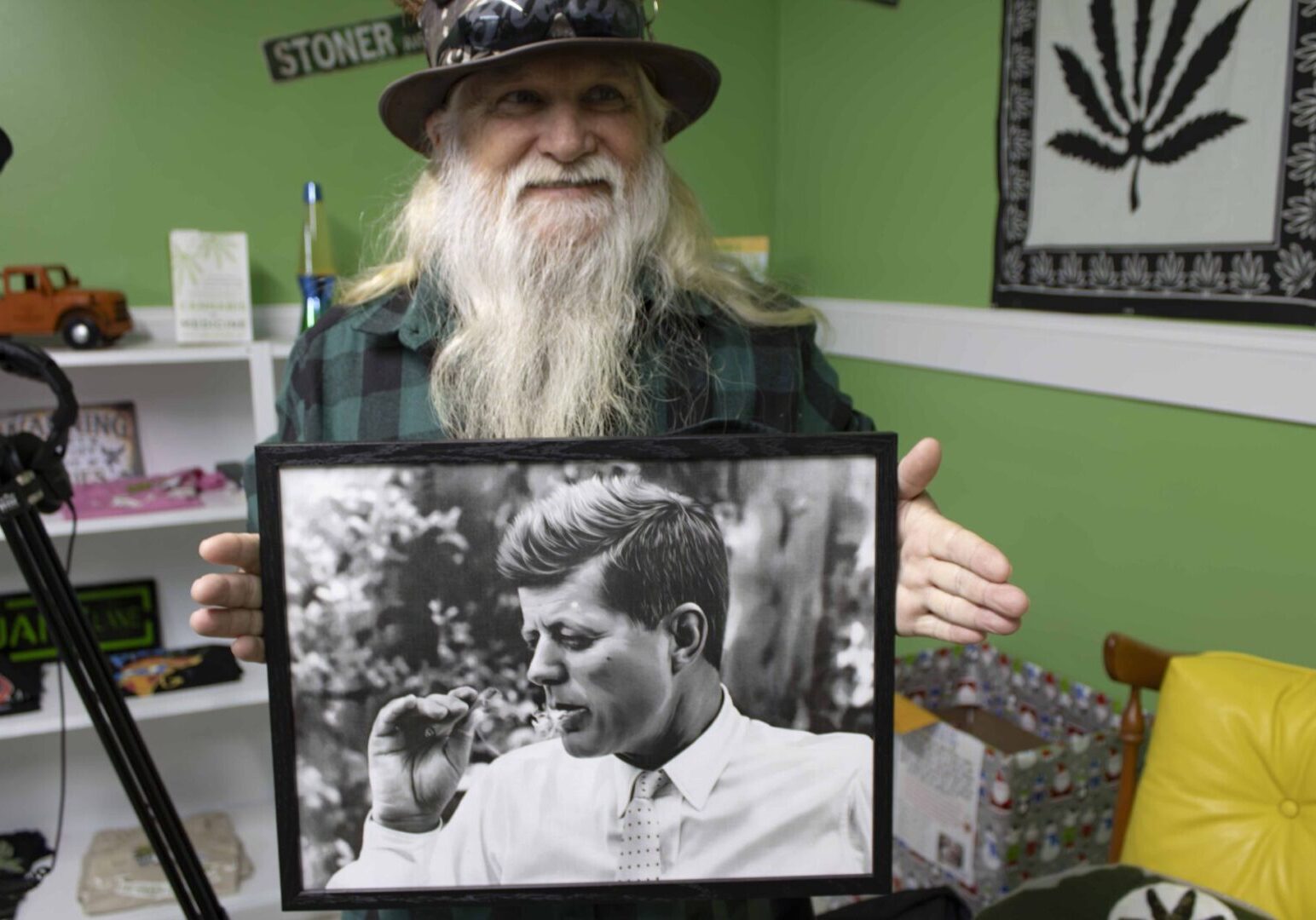 Jeff Williams holding a picture of John F Kennedy smoking.