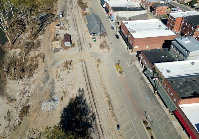 A drone still over Locust Street in Spruce Pine showing the North Toe River, and the efforts made to remove mud from Locust Street after the flooding.