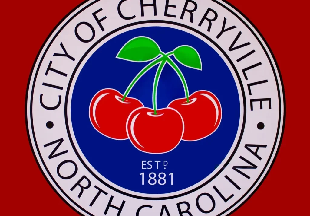 Seal of the City of Cherryville, North Carolina, featuring three cherries on a blue circle background with text "Est. 1881".